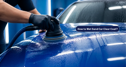 Technician wet sanding clear coat paint runs on a blue car panel - FastPlus Abrasives USA