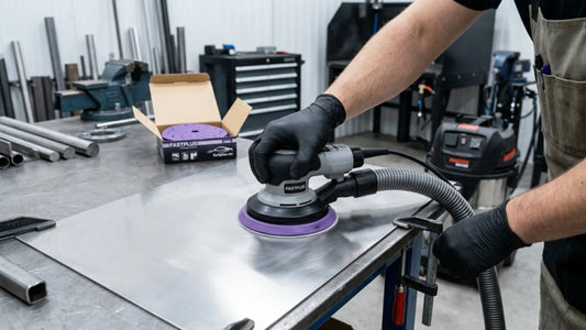 Technician using DA sander on brushed stainless steel surface - FastPlus Abrasives USA