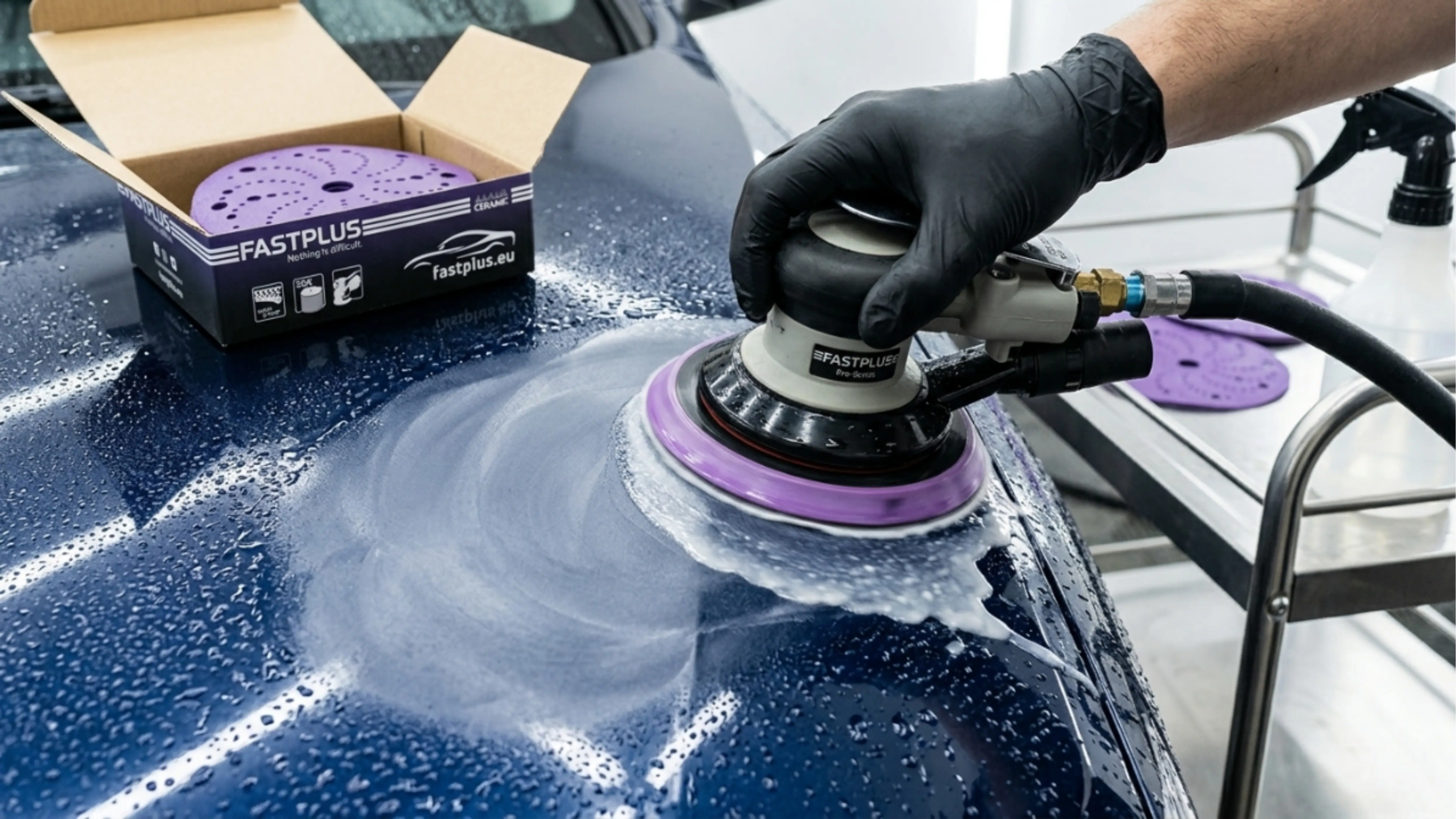 Person using a car polisher on a vehicle's surface with FastPlus branding.
